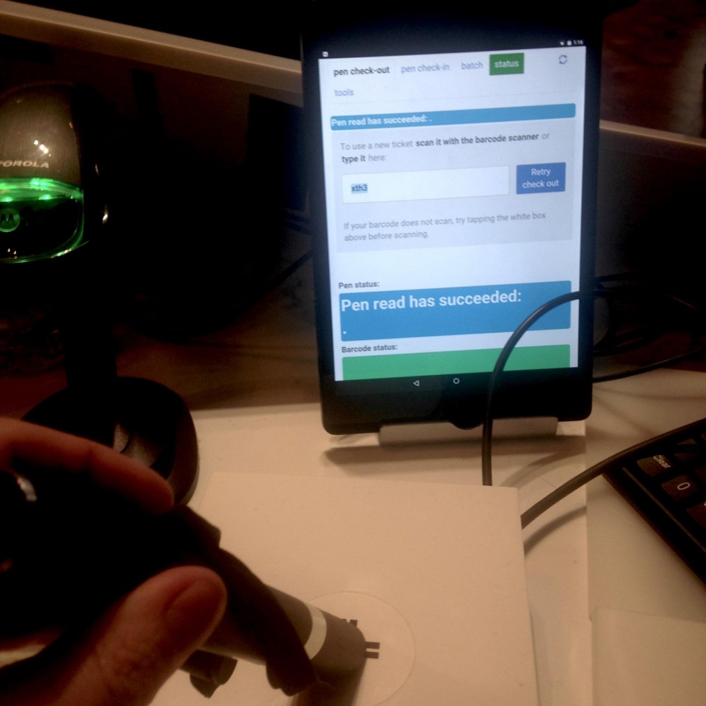 Registration station with tablet and barcode scanner used at ticket counter to pair a ticket and Pen.