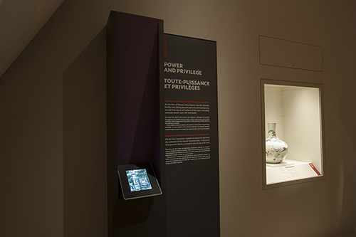A picture of a museum exhibition panel with an iPad below